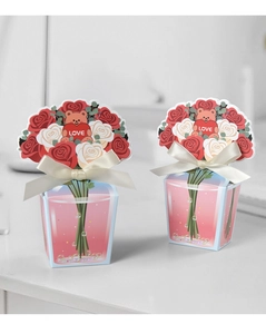 Detail of flower gift box with rose bouquet and small bear holding a LOVE heart sign