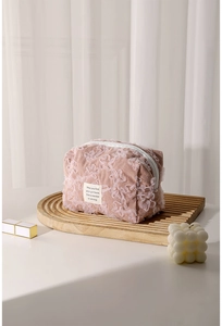 Detail of pink corduroy makeup bag with 3D lace flower embroidery and smooth white zipper