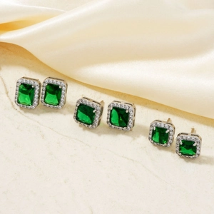 Emerald green square and rectangle cut stud earring set with silver finish on silk fabric