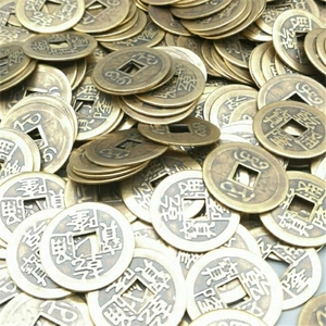 Close-up of antique copper-plated coins with clear Qianlong Tongbao engravings for Feng Shui