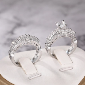 Macro shot of two-piece wedding ring set with cubic zirconia and six-prong mountings