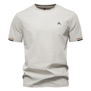 Detailed view of grey cotton T-shirt neckline with size M label and embroidered blue logo