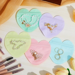 Colorful heart-shaped PVC jewelry storage pouches in five pastel macaron matte finishes