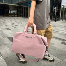 Pink nylon crossbody bag with MICHAD logo detail and adjustable shoulder straps