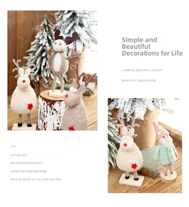 Detail of handmade wool felt reindeer and gnome Christmas ornaments on natural wood bases
