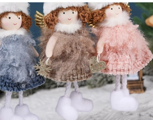 Detail of Christmas angel ornaments in blue brown and pink with golden wings and plush boots