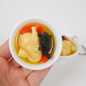 Vista a mano di un portachiavi realistico da 6,5 cm di zuppa di tartaruga e pollo