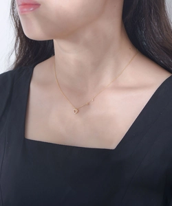 Close-up of S925 silver hollow heart necklace with diamonds on a model neck