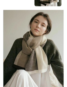 Detailed view of bicolor knit scarf texture in brown and beige wool blend fabric
