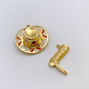 Detailed view of gold cowboy hat and boot pendants with red enamel star accents