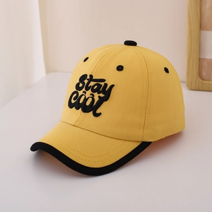 Detail of yellow cotton baseball cap featuring Stay Cool embroidery and black contrast piping
