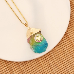 Close-up of rainbow crystal pendant with gold heart motif on a stainless steel chain