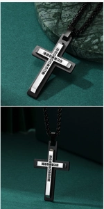 Detail of silver and black stainless steel cross pendant with small black stones inlay