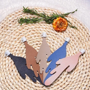 Detailed view of leaf-shaped faux leather coffee bookmarks in five vibrant colors
