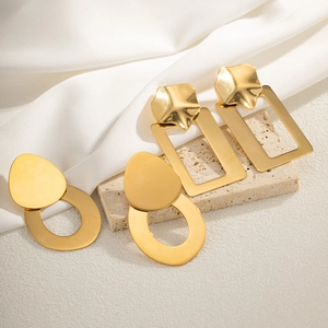 Minimalist gold geometric stainless steel earrings set on stone display base