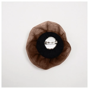 Detailed back view of brown mesh rose brooch with black felt base and silver metal pin