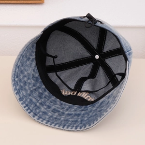Detail of denim bucket hat interior with sweatband, adjustable drawstring and B letter embroidery