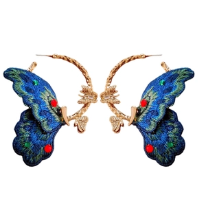 Elegant gold hoop earrings with blue embroidered butterfly wings and colorful gemstones