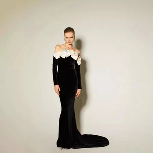 Elegant off-shoulder black velvet fisheye evening gown with white 3D floral accents