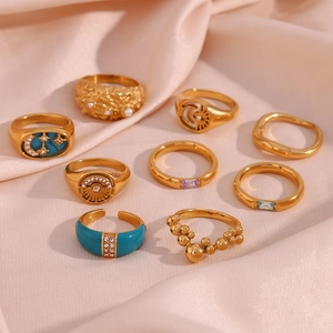 Set of 9 gold-plated rings with blue enamel and moon star patterns on pink silk