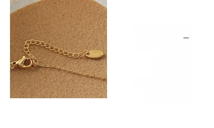 Macro detail of the adjustable chain and lobster clasp with K18 gold hallmark on necklace