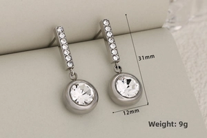 Close-up of silver geometric drop earrings with crystals and dimensions 31mm by 12mm