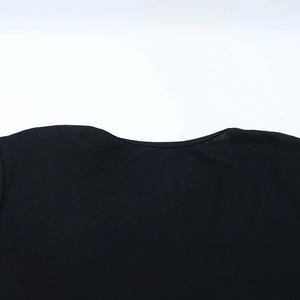 Detail of the V-neckline on a stylish black long-sleeved dress with soft fabric texture
