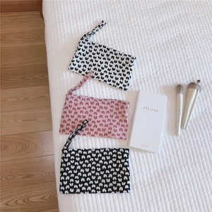 Three-piece set of mini cotton wristlet bags featuring cute heart patterns in various colors