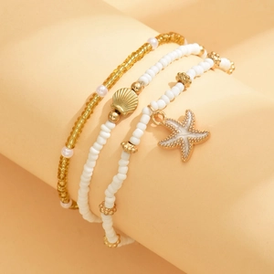 Three-piece bohemian beaded anklet set with starfish and shell charms in gold and white