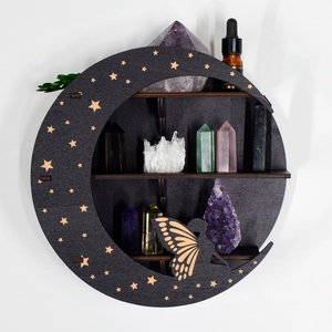 Detailed view of grey moon-shaped wooden shelf with star cutouts and fairy silhouette