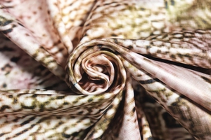 Macro shot of satin fabric with snake print and smooth texture on the sleeveless dress