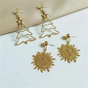 Golden Christmas tree and embossed sun face earrings with metallic alloy finish