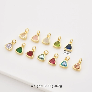 Macro shot of 7mm triangular colorful zircon charms with gold plated borders