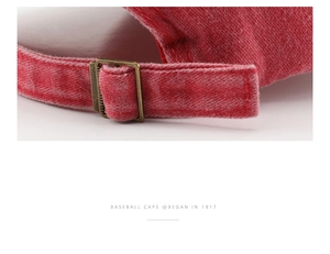 Close-up of adjustable vintage brass buckle and red washed cotton fabric on baseball cap