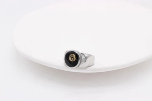 Detail view of silver titanium steel ring featuring a black 8-ball billiard design