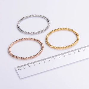 Polished stainless steel beaded bangle set in silver, gold, and rose gold with a ruler