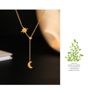 Detailed view of 14K gold plated celestial Y-necklace featuring star and crescent pendants