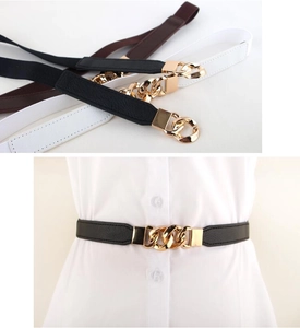 Detailed view of elastic waist belts in three colors with gold chain metal buckles