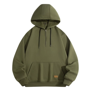 Detail of army green half-zip hoodie with metal zipper, drawstring, and leather label