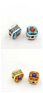 Detail of 10mm Tibetan style barrel beads with Greek key patterns and inlaid resin stones