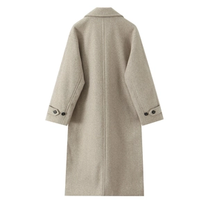 Back view of long minimalist wool coat in soft beige with cuff strap details