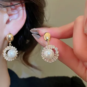 Elegant 18k gold plated pearl drop earrings featuring white round pearls and zircon halo