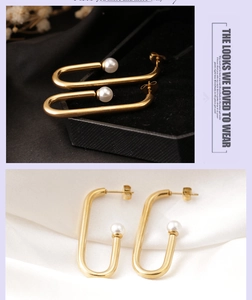 Detail of elegant gold U-shaped earrings with white pearls on satin background