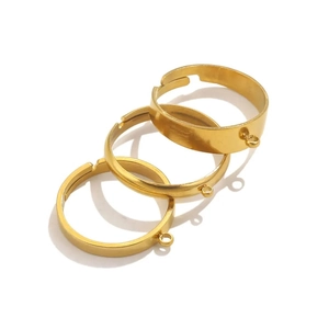 Detailed view of three adjustable golden stainless steel ring bases with small loops
