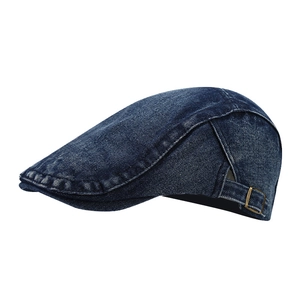 Vintage dark blue denim newsboy cap with adjustable copper buckle in a profile view