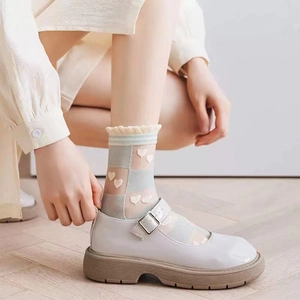 Sheer pastel plaid crew socks with heart patterns and ruffle cuffs worn with Mary Janes
