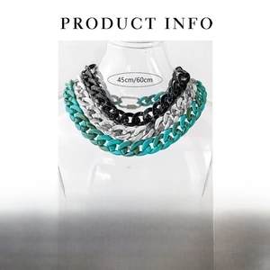 Three acrylic chain necklaces in various colors displayed on a clear glass vessel