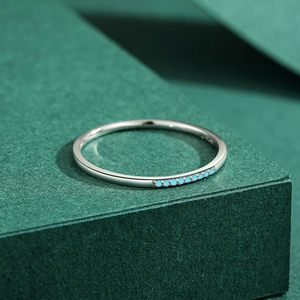 S925 sterling silver minimalist ring set with seven round turquoise stones on a green base