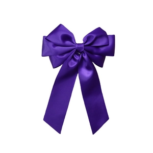 Detailed view of the dark purple satin ribbon texture and multi-layered bow hair clip