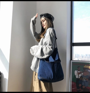Detailed view of dark blue denim tote bag with soft washed texture for daily casual use